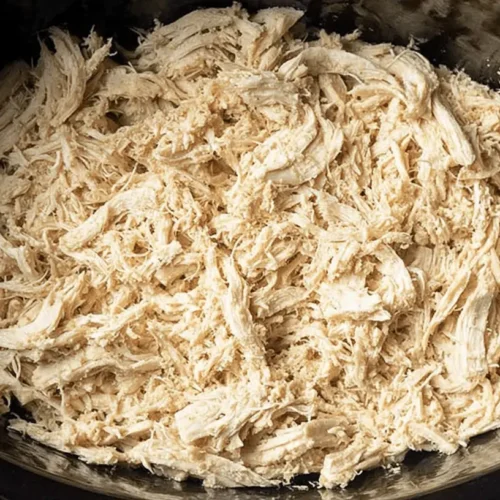 Easy Slow Cooker Shredded Chicken Breast 2 Top-down view of tender Slow Cooker Shredded Chicken Breast in a dark pot, ready to serve.