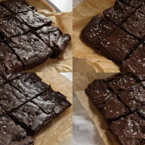 The BEST Flourless Greek Yogurt Brownies Recipe 3 Overhead view of two batches of fudgy flourless Greek yogurt brownies with crackled tops, sea salt, and chocolate chips on parchment paper.