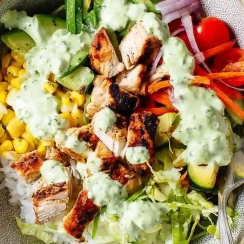 Chicken and Rice Bowls 2 Healthy chicken and rice bowls with grilled chicken, fresh vegetables, corn, avocado, and creamy cilantro dressing.