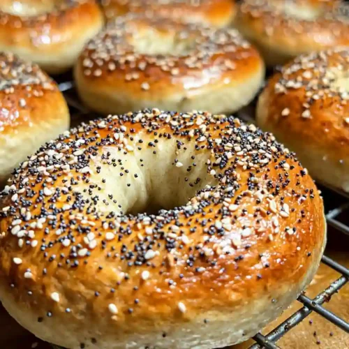 Two-Ingredient Protein Bagels: The Ultimate Guide 3 Freshly baked two-ingredient protein bagels cooling on a wire rack, topped with everything bagel seasoning.