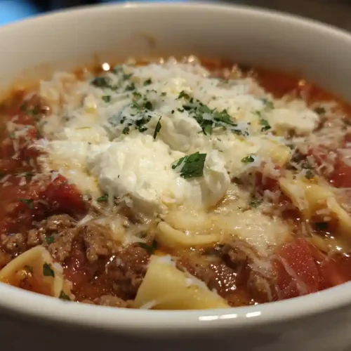 Easy High-Protein One Pot Lasagna Soup 3 High-Protein Lasagna Soup in a white bowl with ground meat, lasagna noodles, and melted cheese.