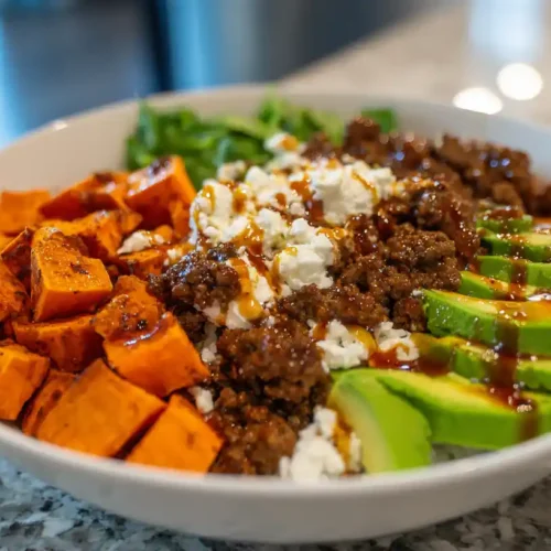 High-Protein Ground Beef Cottage Cheese Bowl 2 High-protein ground beef cottage cheese bowl with avocado slices, roasted sweet potatoes, rice, and savory sauce.