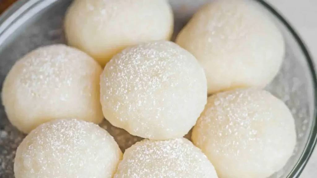 Soft homemade mochi dusted with starch, showcasing chewy Japanese sweet rice cakes arranged in a bowl.