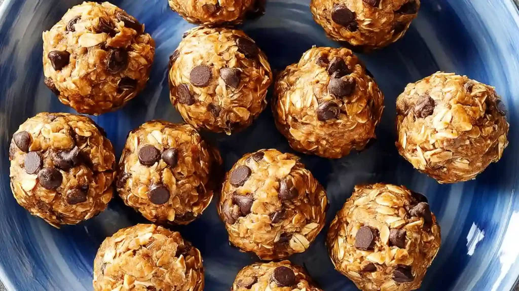 Peanut butter protein balls recipe with oats and chocolate chips arranged on a blue plate.