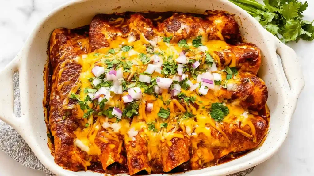 Cheesy beef enchiladas baked in red sauce and topped with cilantro and diced onions.